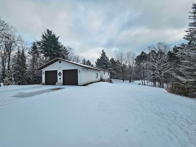 snow covered garage with a garage