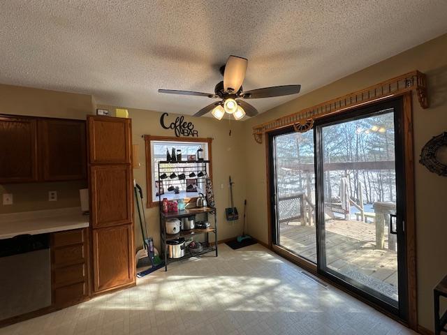 interior space with ceiling fan and a textured ceiling