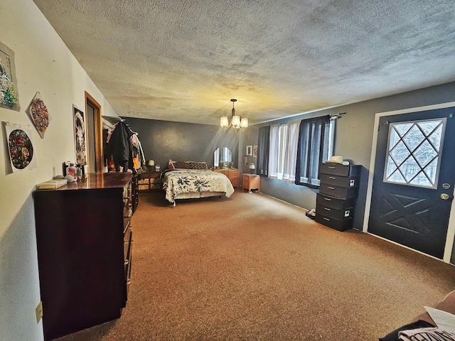 bedroom featuring carpet flooring, a textured ceiling, and an inviting chandelier