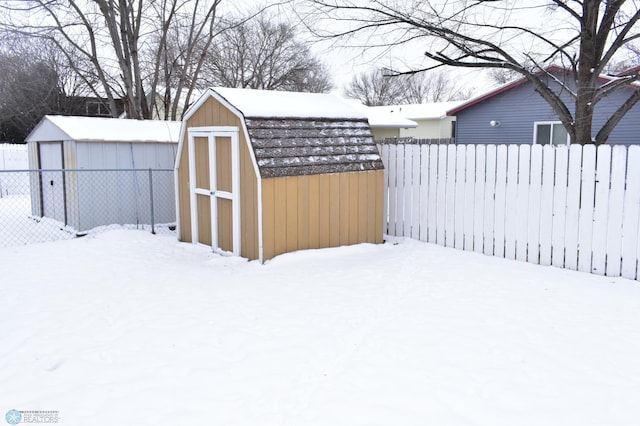 snowy yard with a storage unit