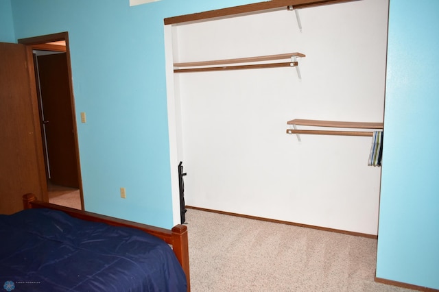 unfurnished bedroom featuring carpet and a closet