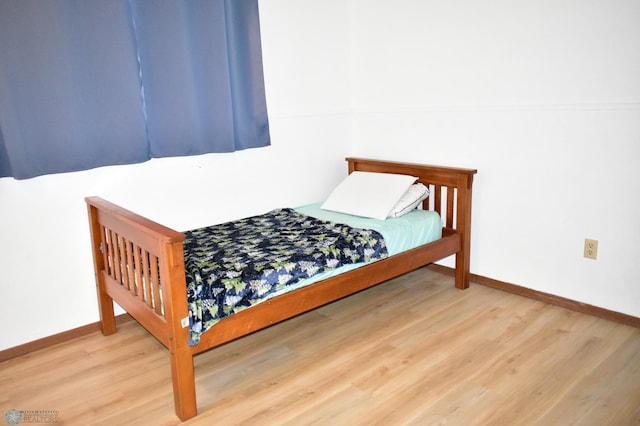 bedroom with hardwood / wood-style floors