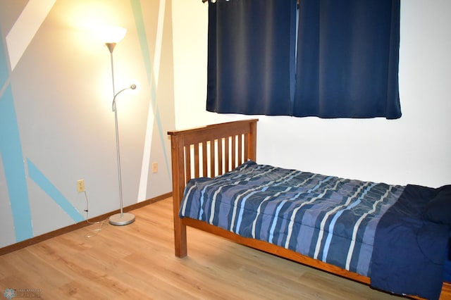 bedroom with wood-type flooring