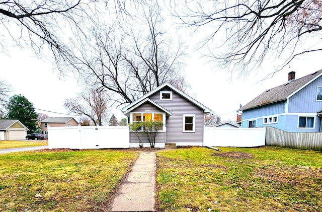 rear view of property with a yard