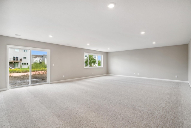 spare room featuring light colored carpet