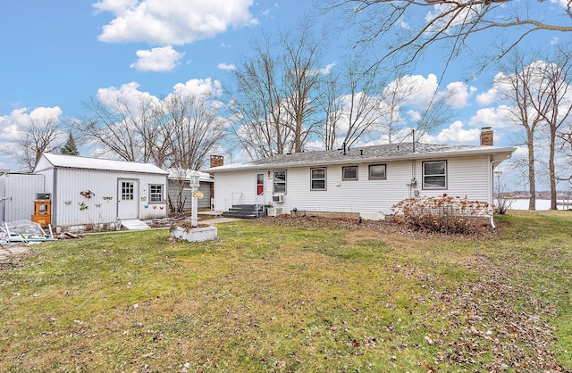 rear view of house with a yard