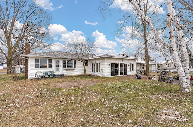 rear view of house with a yard