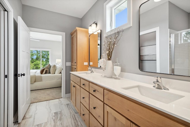 bathroom with a shower with door and vanity