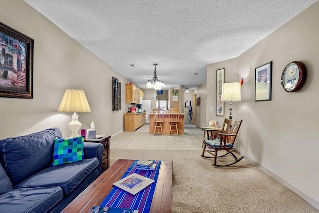 carpeted living room featuring an inviting chandelier and a textured ceiling