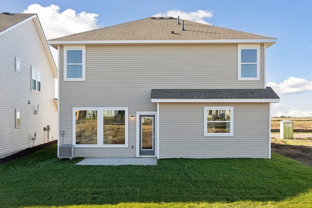 rear view of house featuring a yard, a patio, and cooling unit