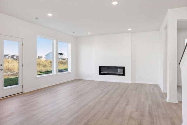 unfurnished living room featuring light wood-type flooring