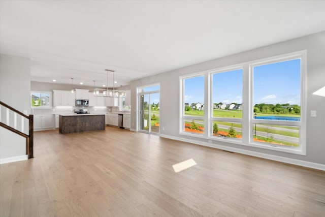 unfurnished living room with light wood-type flooring