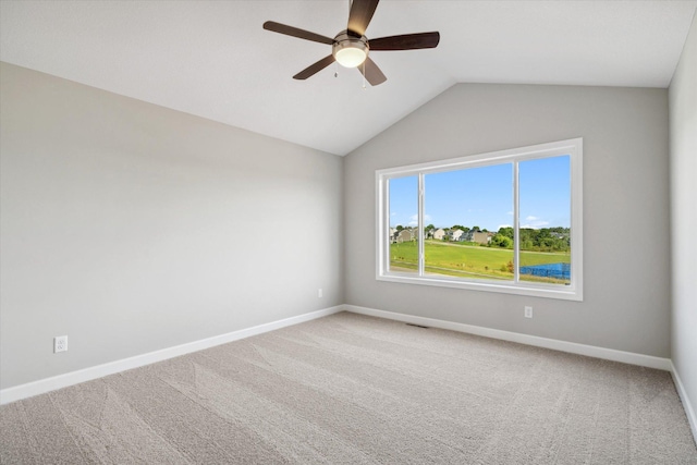 unfurnished room with carpet flooring, ceiling fan, and vaulted ceiling