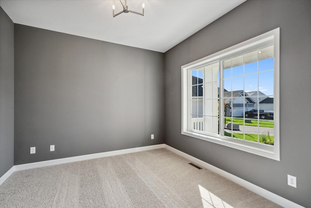 unfurnished room featuring carpet flooring and a healthy amount of sunlight