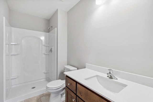 bathroom with tile patterned floors, a shower, vanity, and toilet