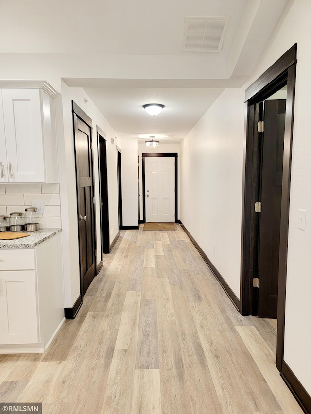 corridor featuring light hardwood / wood-style floors