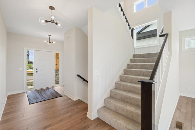 entryway featuring a chandelier, hardwood / wood-style floors, and a wealth of natural light