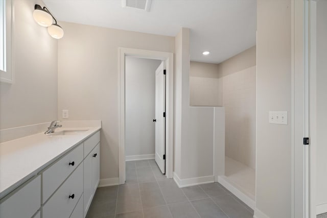 bathroom with tile patterned floors, vanity, and a shower