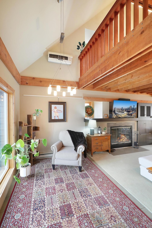 living room featuring a wall unit AC, a fireplace with flush hearth, and high vaulted ceiling