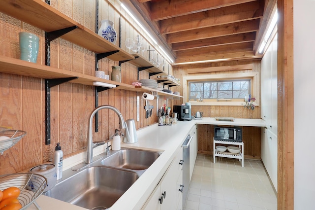 kitchen with open shelves, a sink, black microwave, light countertops, and dishwasher