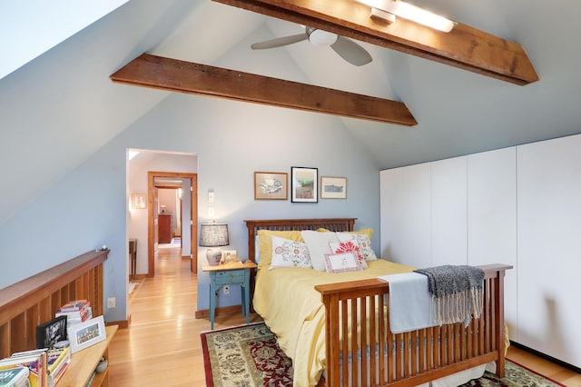 bedroom featuring vaulted ceiling with beams, light wood-style floors, and ceiling fan