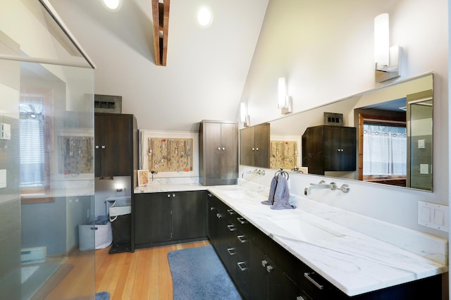 full bath featuring high vaulted ceiling, wood finished floors, and vanity