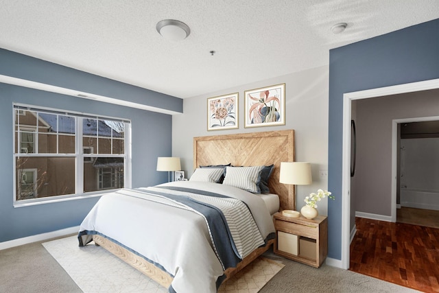 carpeted bedroom with baseboards and a textured ceiling