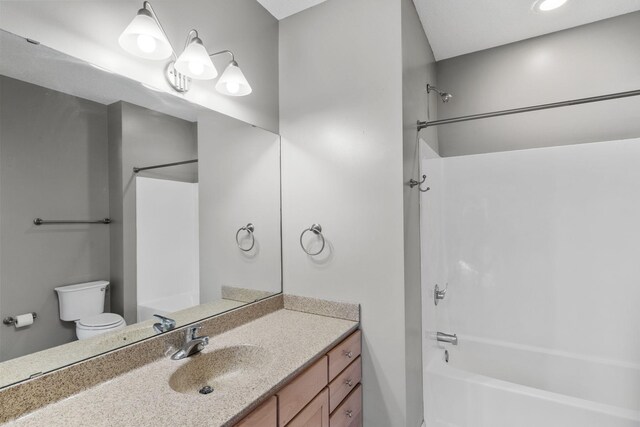 full bath featuring shower / bathtub combination, toilet, and vanity