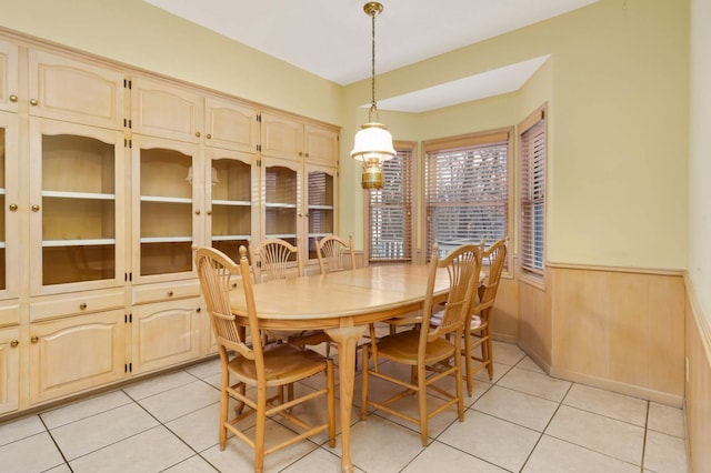 tiled dining space with wood walls