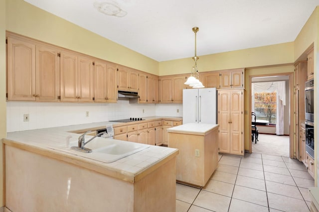 kitchen featuring kitchen peninsula, black electric cooktop, pendant lighting, white fridge, and a kitchen island