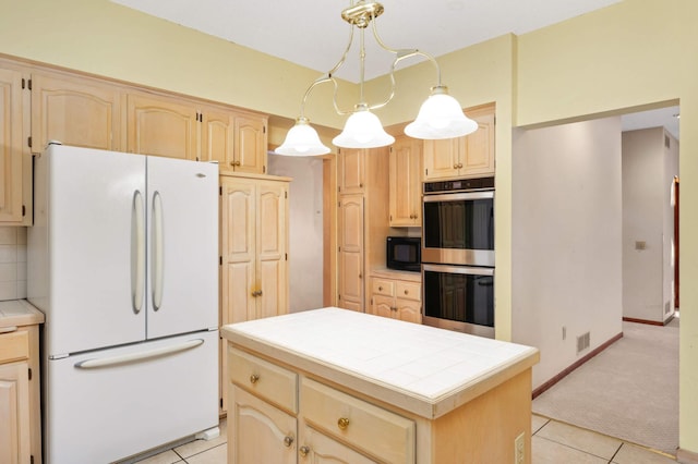 kitchen with pendant lighting, tile countertops, a center island, white refrigerator, and double oven