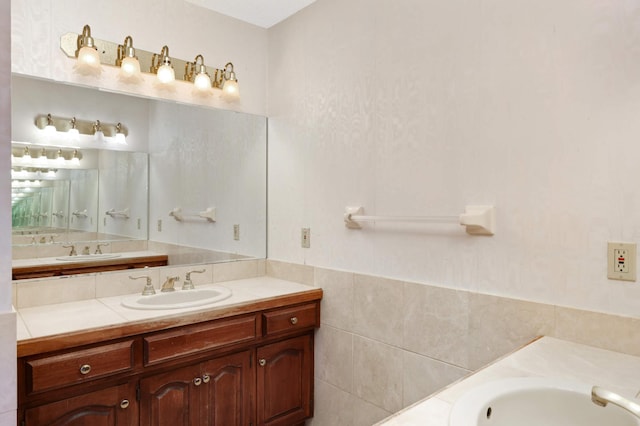 bathroom featuring a washtub, vanity, and tile walls