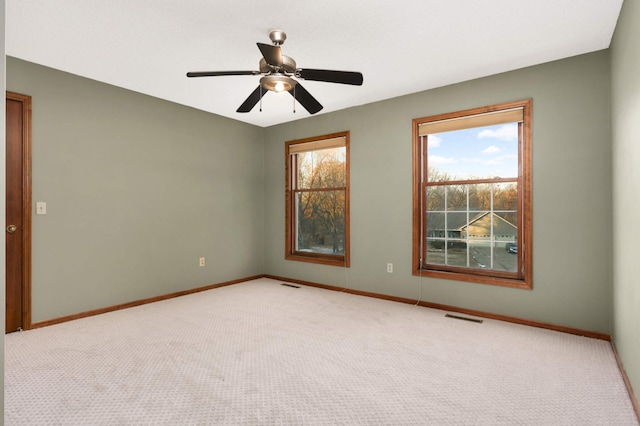 carpeted empty room featuring ceiling fan