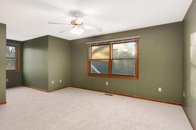 carpeted empty room with ceiling fan