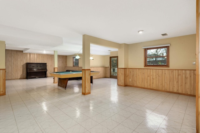 rec room with wooden walls, light tile patterned floors, and billiards