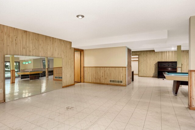 empty room featuring wood walls and pool table