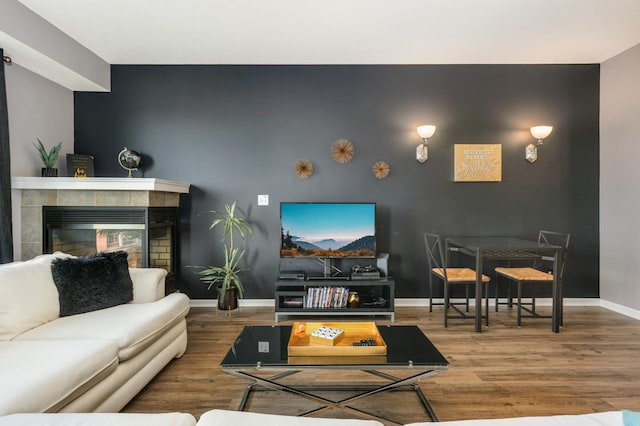 living room with hardwood / wood-style flooring and a fireplace