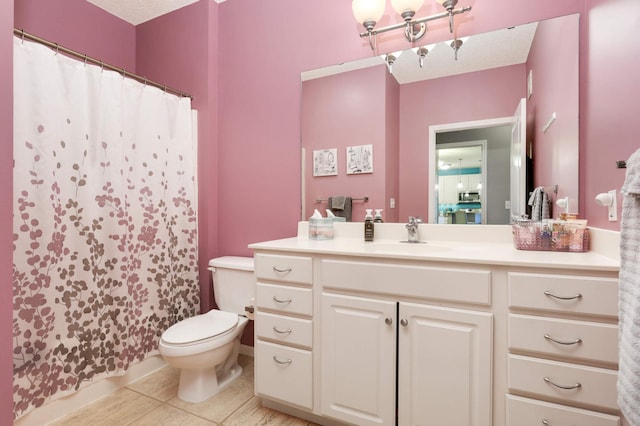 bathroom with tile patterned floors, vanity, toilet, and curtained shower