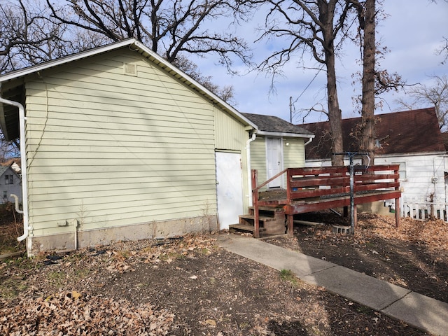 view of side of property featuring a wooden deck