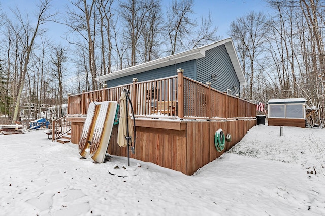 snow covered house featuring a deck