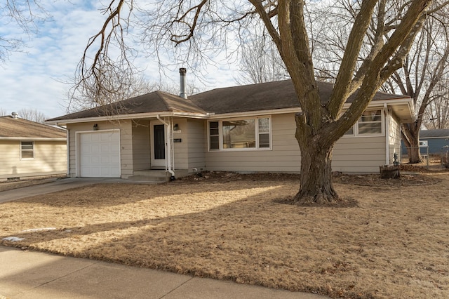 ranch-style house featuring a garage and driveway