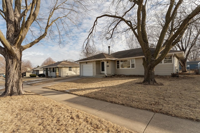 ranch-style house with an attached garage and concrete driveway