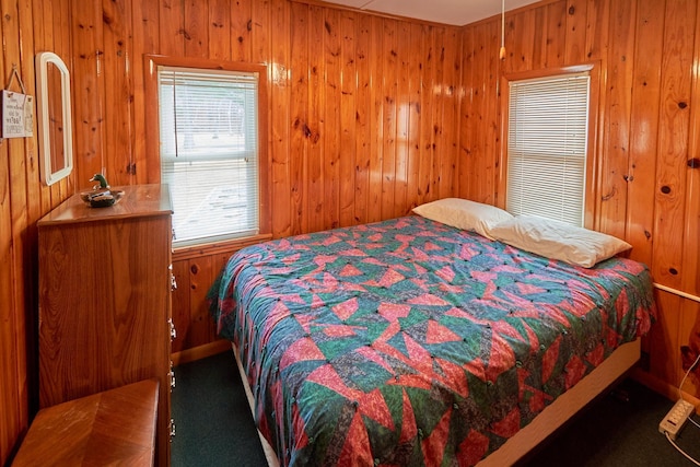 carpeted bedroom with wood walls