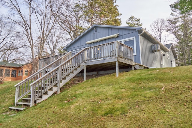 back of property with a wooden deck and a yard