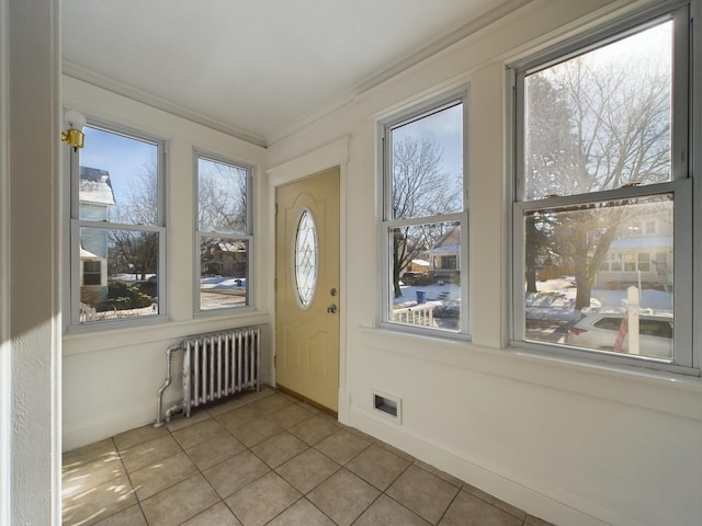 unfurnished sunroom with radiator and visible vents