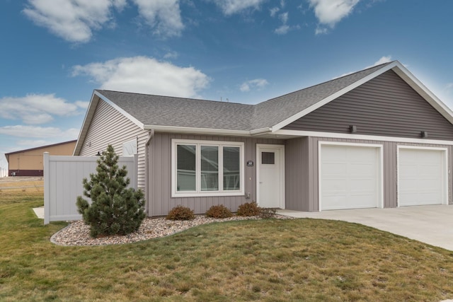 single story home featuring a front yard and a garage