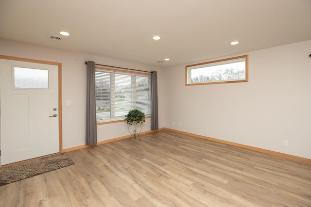 foyer entrance featuring plenty of natural light and light hardwood / wood-style flooring