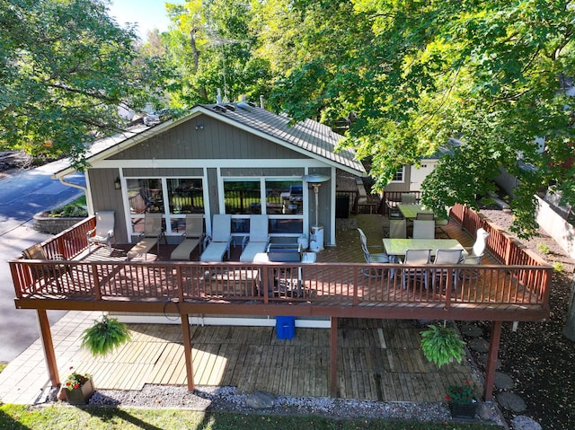 rear view of property featuring a deck