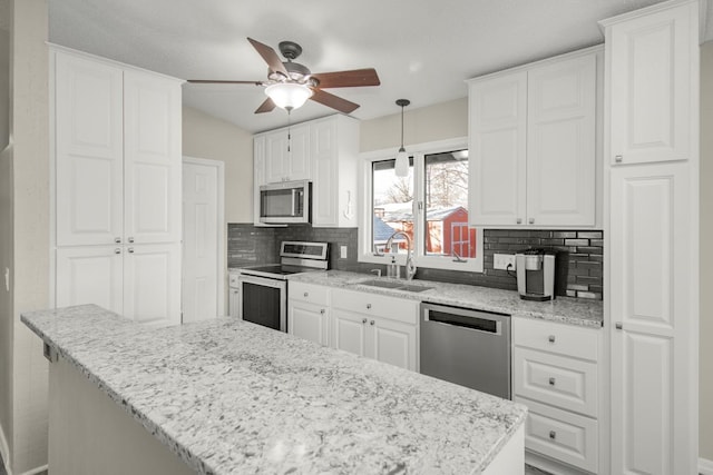 kitchen with white cabinetry, appliances with stainless steel finishes, and sink