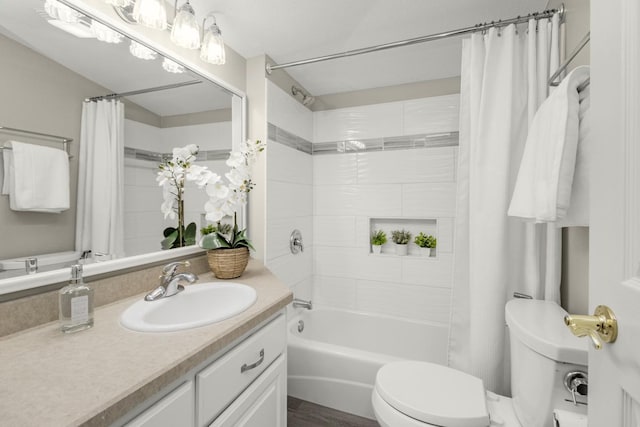 full bathroom with shower / bath combination with curtain, vanity, and toilet